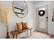 Inviting entryway with a decorative mirror, wooden bench, and stylish decor at 9300 E Florida Ave # 1202, Denver, CO 80247