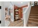 Hallway with staircase, featuring wood floors, stylish decor, and an open floor plan at 9300 E Florida Ave # 1202, Denver, CO 80247