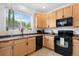 Functional kitchen with stainless steel appliances, cabinetry, and a window providing ample sunlight at 9300 E Florida Ave # 1202, Denver, CO 80247