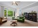 Bright living room features a large window, comfortable seating, and a ceiling fan at 9300 E Florida Ave # 1202, Denver, CO 80247