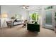 Bright living room featuring a comfortable green sofa, large windows, and modern furnishings at 9300 E Florida Ave # 1202, Denver, CO 80247
