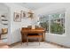 Cozy piano room featuring a piano with bench seat, natural light, and stylish wall art at 9300 E Florida Ave # 1202, Denver, CO 80247