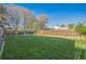 Well-manicured back yard featuring lush, green grass and a wood fence at 3080 N Cook St, Denver, CO 80205