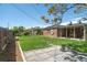 A fully fenced backyard showcases a green lawn and stone walkway, perfect for outdoor enjoyment at 3080 N Cook St, Denver, CO 80205