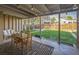 Relaxing covered patio with stylish decor and an open view of the expansive, green backyard at 3080 N Cook St, Denver, CO 80205