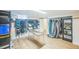 Spacious basement area with hardwood floors, custom gear storage, and versatile layout at 3080 N Cook St, Denver, CO 80205