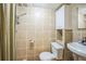 Bathroom featuring tiled walls, vanity with sink, toilet, and shower with curtain at 3080 N Cook St, Denver, CO 80205