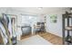 Bright bedroom with natural light, hardwood floors, a clothing rack, a dresser, and a dedicated workspace at 3080 N Cook St, Denver, CO 80205