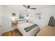 Bright bedroom featuring hardwood floors, a modern ceiling fan and a custom wood headboard with built-in nightstands at 3080 N Cook St, Denver, CO 80205