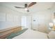 A bright bedroom with clean, white walls, minimalist artwork, and a modern ceiling fan is a peaceful retreat at 3080 N Cook St, Denver, CO 80205