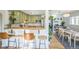 Bright kitchen featuring sage green cabinets, butcher block counters, and a breakfast bar at 3080 N Cook St, Denver, CO 80205