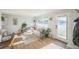 Cozy living room with hardwood floors, comfortable seating, and natural light from a large window at 3080 N Cook St, Denver, CO 80205