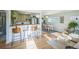 Open-concept living space with hardwood floors connecting kitchen, dining, and living areas at 3080 N Cook St, Denver, CO 80205
