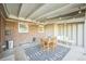 A covered patio with exposed rafters, string lights, and a lounge area provides a great space for outdoor entertaining at 3080 N Cook St, Denver, CO 80205