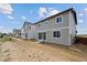 New homes in a developing neighborhood, backyards with newly seeded yards at 45927 Wood Thrush Ave, Bennett, CO 80102