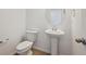 Clean bathroom features modern fixtures and a pedestal sink at 45927 Wood Thrush Ave, Bennett, CO 80102