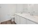 Clean bathroom featuring a double vanity, white cabinets, and modern sink fixtures at 45927 Wood Thrush Ave, Bennett, CO 80102