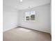 Carpeted bedroom with window that filters light to create a serene and inviting atmosphere at 45927 Wood Thrush Ave, Bennett, CO 80102