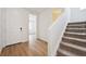 Bright entryway with wood floors and staircase leading to the second floor at 45927 Wood Thrush Ave, Bennett, CO 80102