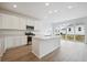 Bright, modern kitchen with white cabinets, an island, and stainless steel appliances at 45927 Wood Thrush Ave, Bennett, CO 80102