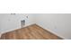 Compact laundry area with wood-look flooring, and essential hookups for appliances at 45927 Wood Thrush Ave, Bennett, CO 80102