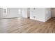 Spacious open-concept living room with modern flooring and plenty of natural light at 45927 Wood Thrush Ave, Bennett, CO 80102
