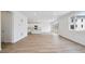 Bright living room with wood floors and a white kitchen that offers an island for gatherings at 45927 Wood Thrush Ave, Bennett, CO 80102