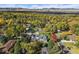 Stunning aerial view of single Gathering homes nestled in the neighborhood surrounded by mature trees at 34 Skyline Dr, Wheat Ridge, CO 80215