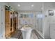 Spa bathroom featuring a modern soaking tub, glass shower, and stylish tile floors at 34 Skyline Dr, Wheat Ridge, CO 80215