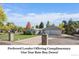 Charming single-story home with an attached two car garage, lush green lawn, and mature trees at 34 Skyline Dr, Wheat Ridge, CO 80215