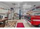 Spacious garage with car lift, mechanic tools, a red truck and ample storage at 34 Skyline Dr, Wheat Ridge, CO 80215