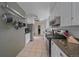 Modern kitchen featuring white cabinets, stainless steel appliances, granite countertops, and tile floors at 34 Skyline Dr, Wheat Ridge, CO 80215