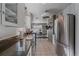 Modern kitchen featuring white cabinets, stainless steel appliances, granite countertops, and tile floors at 34 Skyline Dr, Wheat Ridge, CO 80215