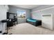 Bedroom with desk, dresser, a daybed, and a large window overlooking the backyard at 5604 S Shawnee St, Aurora, CO 80015