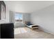 Bedroom featuring a simple bed frame, carpeted floors, and a large picture window at 5604 S Shawnee St, Aurora, CO 80015