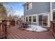 Back deck featuring a patio set, wood floors, and exterior access to the interior of the home at 5604 S Shawnee St, Aurora, CO 80015