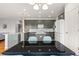 Modern kitchen features gray cabinets, a center island, and stainless steel appliances at 5604 S Shawnee St, Aurora, CO 80015