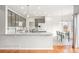 Open kitchen with granite countertops, tile backsplash, and eat-in dining area at 5604 S Shawnee St, Aurora, CO 80015