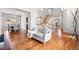 Open-concept living space with hardwood floors, staircase, and adjacent dining area at 5604 S Shawnee St, Aurora, CO 80015