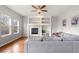Bright living room features hardwood floors, fireplace, and a large comfy couch at 5604 S Shawnee St, Aurora, CO 80015