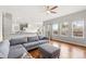 Open-concept living room flows into the kitchen and features large windows and hardwood floors at 5604 S Shawnee St, Aurora, CO 80015