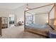 Spacious main bedroom with en suite bathroom and four-poster bed at 5604 S Shawnee St, Aurora, CO 80015