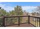 Enjoy the outdoors on this deck with black metal railings and views of mature trees and neighborhood at 7356 S Miller Ct, Littleton, CO 80127