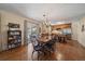 Dining room with hardwood floors, stylish chandelier, and access to the deck at 7356 S Miller Ct, Littleton, CO 80127