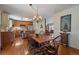 Elegant dining room with a large wooden table and direct access to the kitchen at 7356 S Miller Ct, Littleton, CO 80127