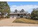 Charming two-story home with three-car garage, dormer windows, inviting front porch and manicured lawn at 7356 S Miller Ct, Littleton, CO 80127