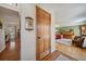 Welcoming foyer featuring hardwood floors and an open view into the spacious living room at 7356 S Miller Ct, Littleton, CO 80127