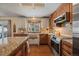 Stylish kitchen featuring granite countertops, custom cabinets, and stainless steel appliances at 7356 S Miller Ct, Littleton, CO 80127