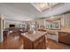 Open kitchen featuring granite counters, island, and an eat-in dining area that flows to the living room at 7356 S Miller Ct, Littleton, CO 80127