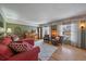 Bright and airy living room with large windows, hardwood floors, and comfortable seating at 7356 S Miller Ct, Littleton, CO 80127